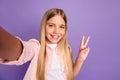 Photo of cheerful long hairdo pretty girl doing selfie show v-sign wear pink shirt isolated on violet color background Royalty Free Stock Photo