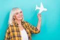 Photo of cheerful mature woman airplane tourism vacation weekend isolated over teal color background