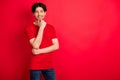 Photo of cheerful nice clever guy hand chin look camera white smile wear red t-shirt isolated red color background Royalty Free Stock Photo