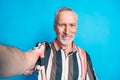 Photo of cheerful nice man wear striped trendy clothes make selfie isolated on blue color background Royalty Free Stock Photo