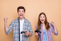 Photo of cheerful positive casual white brown haired couple playing playstation video games rejoicing with victory Royalty Free Stock Photo