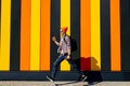 Photo of cheerful positive excited running jumping hipster man with briefcase striving for success against colorful wall Royalty Free Stock Photo