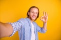 Photo of cheerful positive funky handsome checkered guy showing you ok sign taking selfie approving actions wearing blue