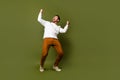 Photo of cheerful positive glad nice man wear trendy white clothes shouting yeah empty space isolated on khaki color Royalty Free Stock Photo