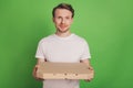 Photo of cheerful positive gourmet pizza lover man hold delivery box wear white t-shirt on green color background