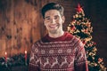 Photo of cheerful positive happy young man xmas good mood smile christmas tree indoors inside house home Royalty Free Stock Photo