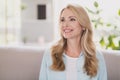 Photo of cheerful positive inspired lady look side dream toothy smile wear blue shirt home apartment indoors