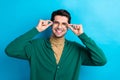 Photo of cheerful positive man wear green cardigan arms spectacles smiling isolated blue color background Royalty Free Stock Photo
