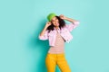 Photo of cheerful positive nice cute millennial girl wearing yellow pants trousers striped t-shirt expressing emotions Royalty Free Stock Photo