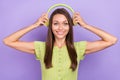 Photo of cheerful positive woman put head headphones music lover smile isolated on violet color background