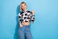 Photo of cheerful pretty lady wear dalmatian print clothes showing thumb empty space isolated blue color background