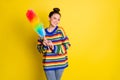 Photo of cheerful pretty young woman stand empty space hold colorful feather cleaner isolated on bright yellow color Royalty Free Stock Photo