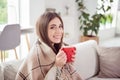 Photo of cheerful serene lovely pretty lady hold mug tea sit couch toothy smile wear blue shirt home indoors