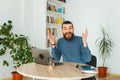 Photo of cheerful surprised office worker looking at the camera