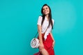 Photo of cheerful sweet lady dressed white crop top purse smiling looking empty space isolated turquoise color