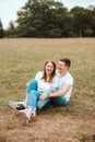 Photo of cheerful young couple laying on grass in park and smiling Royalty Free Stock Photo