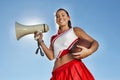 Cheerleader Holding Football and Megaphone