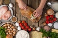 In the photo, the chef prepares pieces of dough for the filling. Lots of bright, colorful ingredients. Rough wooden table. Bright