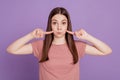 Photo of childish funny lady pointing fingers bloated cheeks isolated on purple background