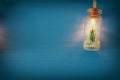 photo of Christmas tree in the masson jar garland light over wooden blue background. Royalty Free Stock Photo