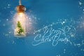 photo of Christmas tree in the masson jar garland light over wooden blue background.