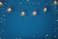 photo of Christmas tree in the masson jar garland lights over wooden blue background.