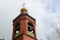 Church bell tower with a Golden dome and a cross against the sky in Russia Royalty Free Stock Photo