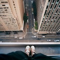 A photo of a city street taken down from a high-rise building, a skyscraper,