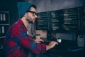 Photo of clever cool coder dressed hat glasses creating program modern gadget indoors workplace workstation loft