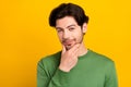 Photo of clever intelligent cunning guy think finger chin wear green pullover isolated yellow color background