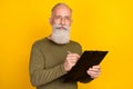 Photo of client old man hold clipboard sign contract wear specs green shirt isolated yellow color background Royalty Free Stock Photo