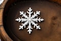 Close-up of a snowflake on a rusty barrel