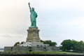 Photo close-up of the Statue of Liberty on a sunny day and blue sky with clouds. Liberty Island. NYC, USA Royalty Free Stock Photo