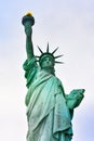 Photo close-up of the Statue of Liberty on a sunny day and blue sky with clouds. Liberty Island. NYC, USA Royalty Free Stock Photo