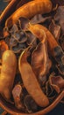 Photo Close up of succulent ripe tamarind pod nestled with dried ones