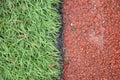 Photo of closeup artificial track and field with green grass combined with artificial grass