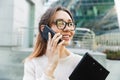 Photo closeup of beautiful caucasian woman talking on cellphone while walking in big city street Royalty Free Stock Photo