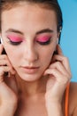 Photo closeup of brunette focused woman posing and using earpods