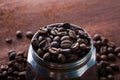 Photo closeup of coffee beans in Aluminium Espresso Coffee Maker. Rusty background. Royalty Free Stock Photo