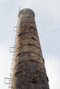 Photo closeup of factory pipe polluting air, on the background of sky