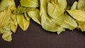 Photo of closeup green texture of bay leaf on black background, top view, copy space Royalty Free Stock Photo