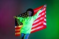 Photo of clubber lady hold american flag wear headphones glasses hoodie  gradient green neon background Royalty Free Stock Photo