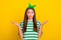 Photo of clueless pretty girl arms palms shrug shoulders do not know isolated on yellow color background