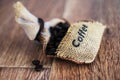 Photo of coffee.Bag with coffee beans on the wood backround.Food photo.