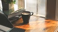 Photo of Coffee cup, stack of books, pencil, potted plant, computer tablet with keyboard case flat lay on wooden table. Royalty Free Stock Photo