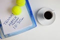 Coffee cup with tennis balls and note on surface Royalty Free Stock Photo