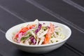 Cole Slaw in White Bowl on Black Table with Copy Space Royalty Free Stock Photo