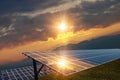 Photo collage of sunset and solar panel, photovoltaic, alternative electricity source Royalty Free Stock Photo