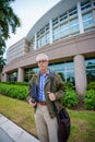 Photo of a college professor with satchel and notebook