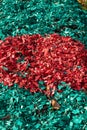 Photo of colored wood chips in autumn flower beds. Royalty Free Stock Photo